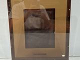 a picture of a dog that is looking out of a window
