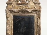 a gold frame with a picture of a bird on it