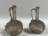 paire de vases anciens en verre argenté avec des anses, sur fond blanc
