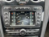 the dashboard of a car with a digital clock and a steering control