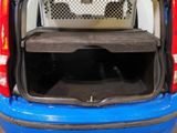 a dog sitting in the back of a car with its trunk open