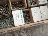 many boxes of screws in a box on the floor