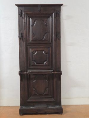 a tall wooden cabinet in the corner of a room