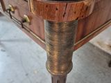 a wooden table with a glass top and metal legs