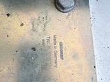 a close up of a metal plate with nuts on it