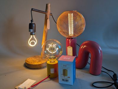 a lamp that is on a table next to a box and a lamp