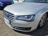 a silver audi parked in a parking lot with other cars in the background