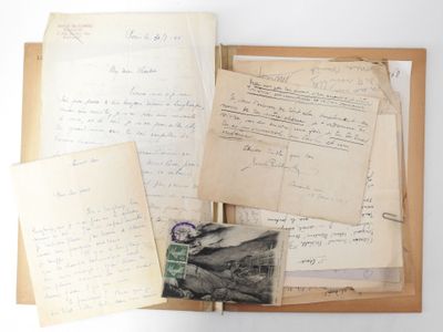 an old book with a bunch of papers on top of it