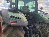 a tractor that is parked on the side of the road