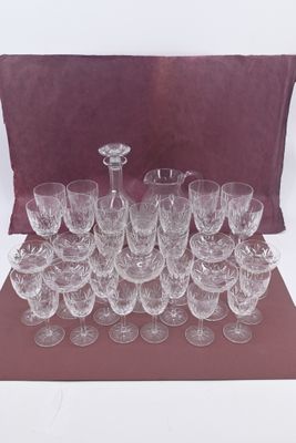 a lot of wine glasses and a pitcher on the table