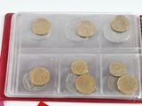 a plastic container with coins inside of it on a table