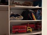 a closet with a lot of toys on the shelves