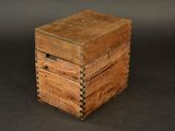 an old wooden box sitting on top of a black surface
