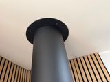 a black pipe on the ceiling of a room