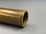 a close up of a brass pipe on a white surface