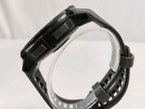a close up of a watch on a clear stand