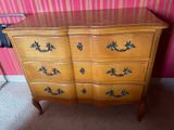 an image of a dresser in a room with pink wallpaper