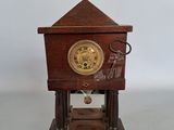 a small wooden clock that is sitting on a table