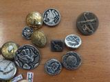 a lot of buttons on a table that are on top of each other