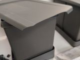two gray boxes sitting on top of a table
