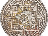 a close up of a silver coin with a design on it