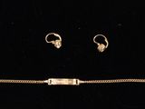 an image of a gold bracelet and earring set on a black background