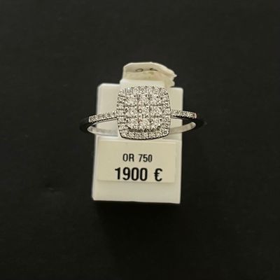 a close up of a ring on a black surface with a price tag