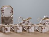 a lot of cups and saucers on a table