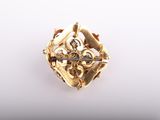 a gold and diamond broochle