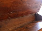 a close up of a wooden bench in a room