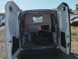 a white van with its door open in a parking lot