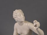 a statue of a man holding a bird in his hand