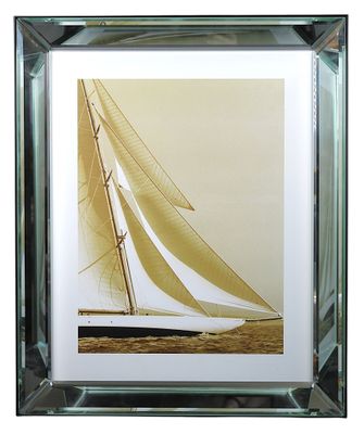 framed photograph of a sailboat in a glass frame on a white background