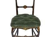 an image of a chair with a green velvet seat and gold trim