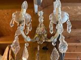 a glass chandelier hanging from the ceiling of a room