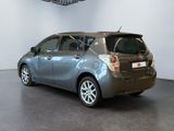 a silver toyota yaris parked in a showroom