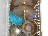 a basket with tea cups and teapots inside of it