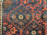 an old rug with a blue and red design on it