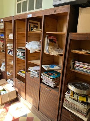 a room with a lot of books and boxes on the floor