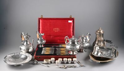 an assortment of silverware including teapots, cups, and spoons
