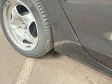 a close up of a car ' s tire on the side of the road