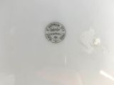 a close up of a white bowl with a black label on it