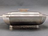 an image of a silver plate with a lid on a stand