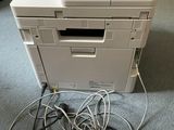 a white printer sitting on top of a pile of wires