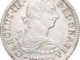 une pièce en argent avec l'image d'une femme de profil