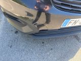 a reflection of a man on the front of a car