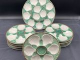 a set of six green and white plates with flowers on them