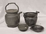 three pots and a teapot on a white background