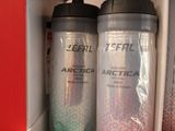two water bottles and a remote on a shelf