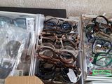 many pairs of glasses sitting in a box on a table